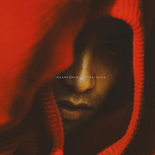 Close-up of a person’s face partially obscured by red fabric.