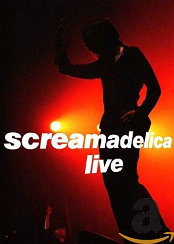 Silhouetted musician performing live with red stage lighting and text “Screamadelica Live”.