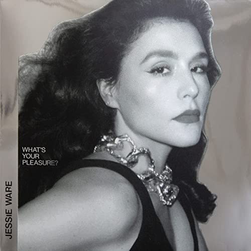 Black and white portrait of Jessie Ware with silver jewelry.
