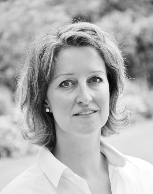 Black and white portrait of a woman with short, wavy hair.