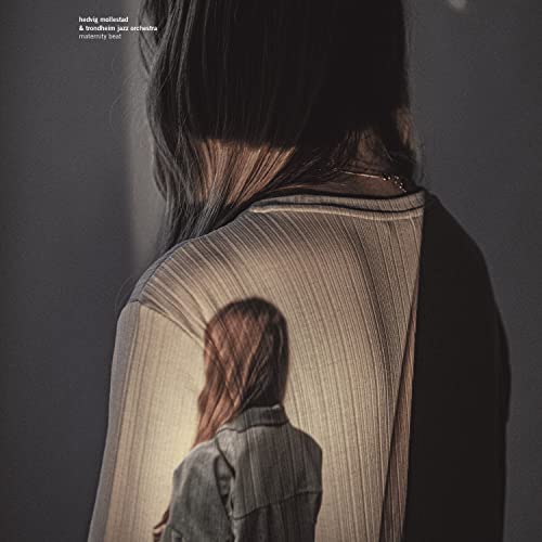 CD cover: woman’s back and reflected figure in muted, textured tones.