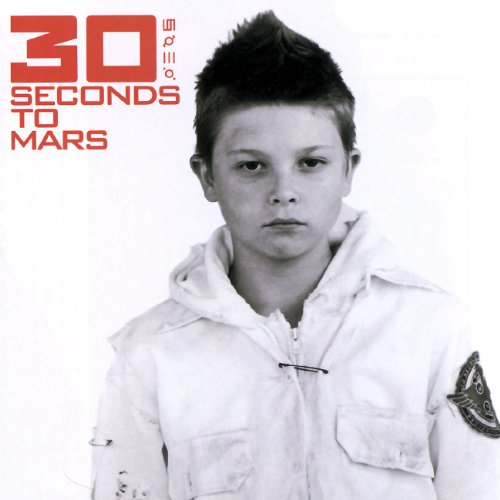 Album cover featuring a young boy in a white jacket with red band text.