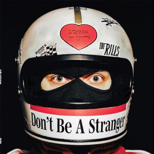 White motorcycle helmet with visible eyes and album title text.