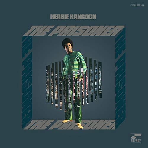 Herbie Hancock album cover, “The Prisoner,” featuring a man in front of buildings.