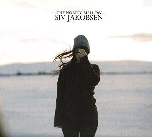 CD cover: woman in a hat facing away, snowy landscape background.