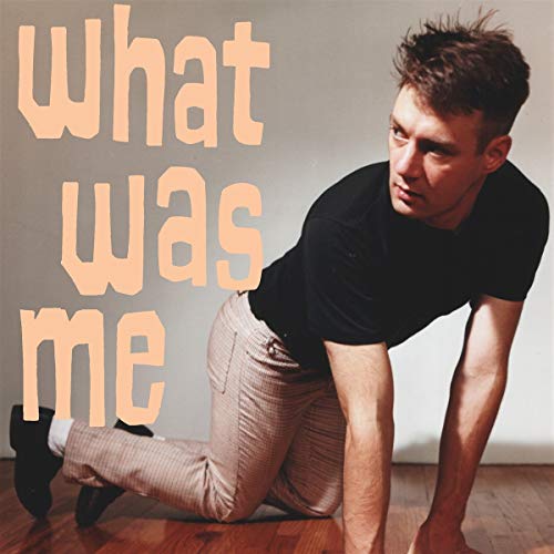 Album cover: man kneeling, text "What was me" in peach lettering.