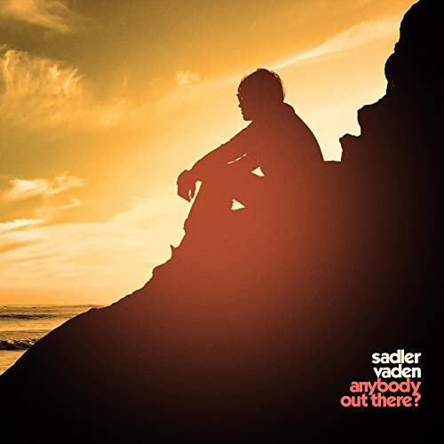 Silhouette of a person sitting on a rock at sunset, CD cover.