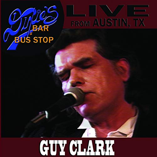 Guy Clark singing into a microphone at a live performance.