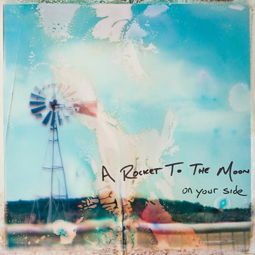 Vinyl album cover with a windmill, clouds, and handwritten text.
