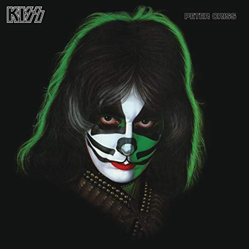 Peter Criss of Kiss with black hair, green highlights, and face paint.