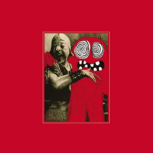 Vintage photo of a woman and a red, spiraled-eye monster figure.