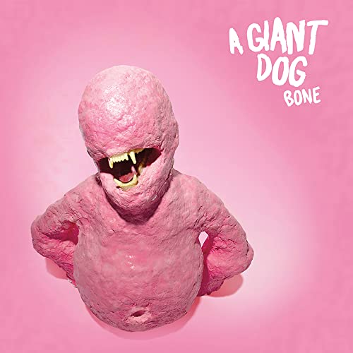 Pink textured creature with an open mouth and sharp teeth on a pink background.