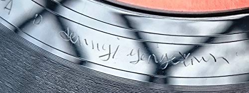 Close-up of a vinyl record label with engraved cursive text.
