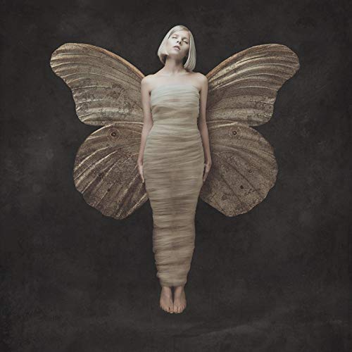 Woman with large moth-like wings, pale skin, and neutral-toned dress.