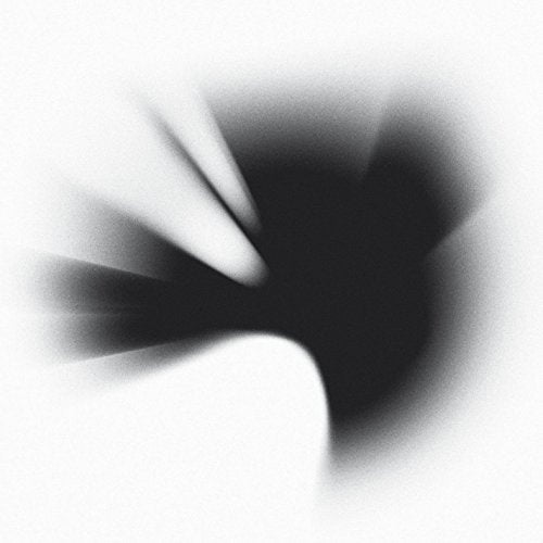 A blurry, dark, bird-shaped silhouette radiates outward against a white background.