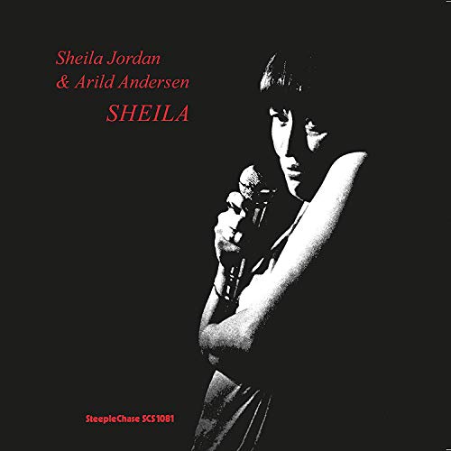 Black and white portrait of Sheila Jordan singing into a microphone.