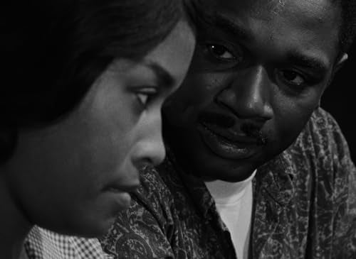 Black and white close-up of two people looking intently forward.