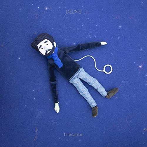Blue album cover featuring a felt doll lying on a textured surface.
