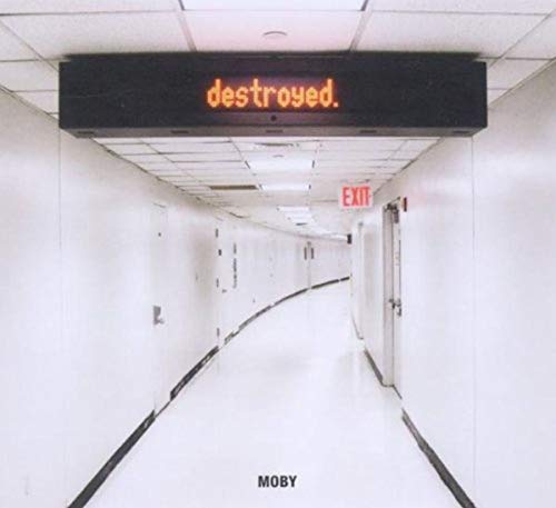 Moby's "Destroyed" album cover: a long, white hallway with a red sign.