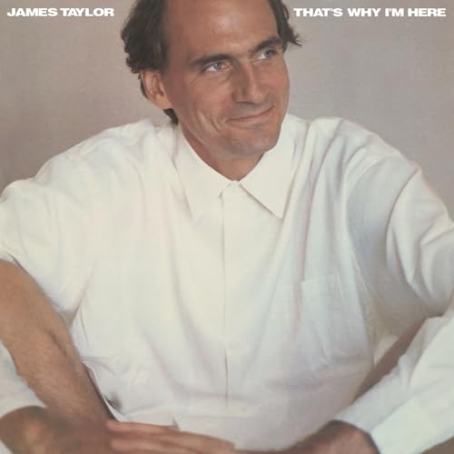 James Taylor album cover, portrait of a smiling man in a white shirt.