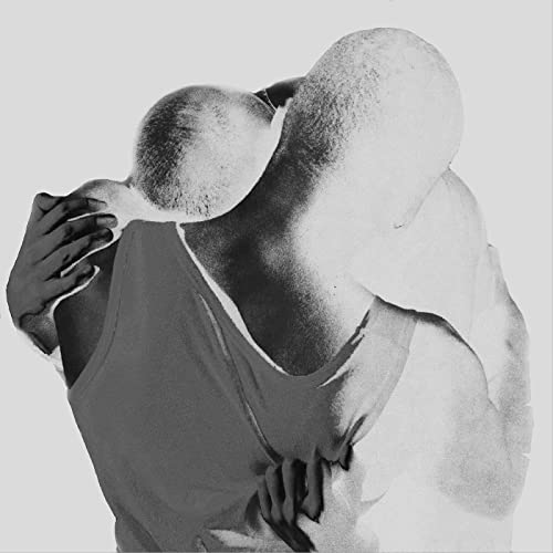 Black and white image of two figures in a close, overlapping embrace.
