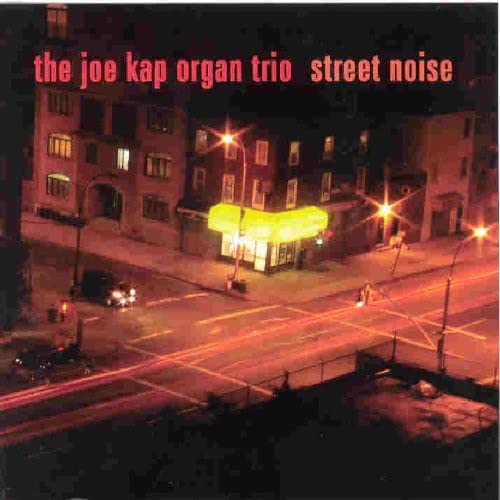 CD cover for “Street Noise” by The Joe Kap Organ Trio, city street scene.
