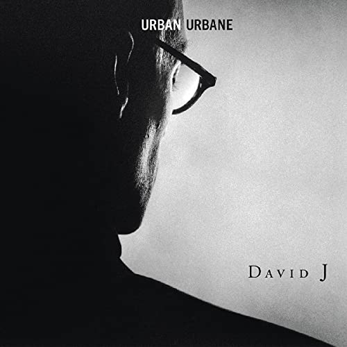 Black and white album cover featuring a profile of a man in glasses.