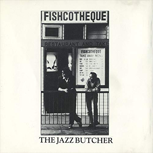 Black and white album cover featuring two people in front of a shop.