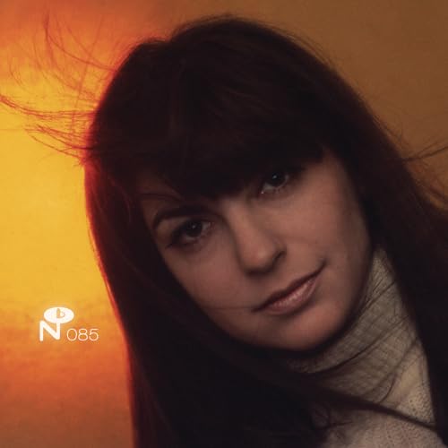 Close-up portrait of Margo Guryan with warm orange and brown tones.