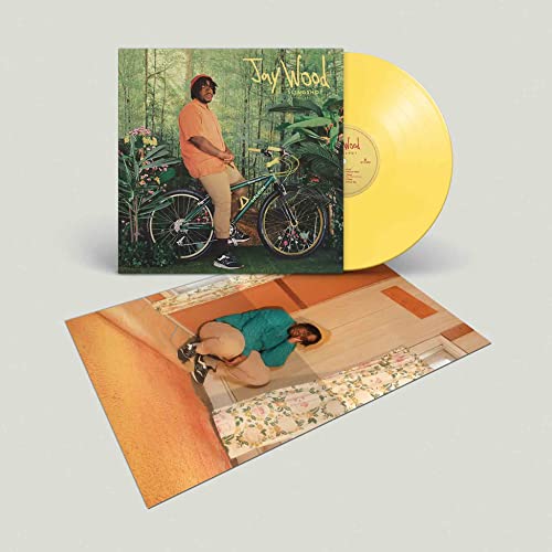 Yellow vinyl record, album cover with man and bicycle, inner sleeve.