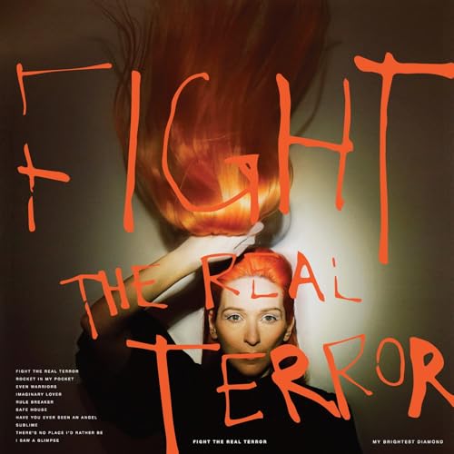 Album cover: woman with red hair and bold orange text.
