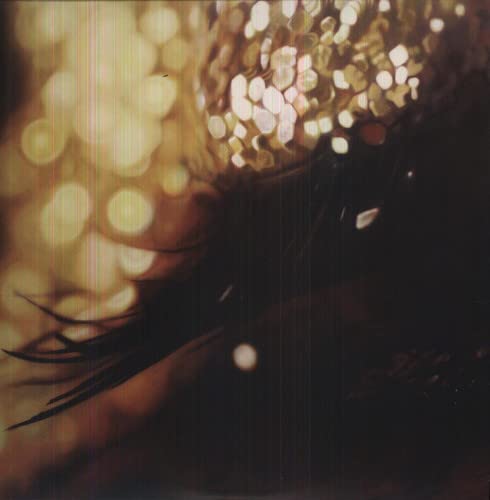 Blurred golden bokeh lights overlay a dark, abstract image with vertical scanning lines.