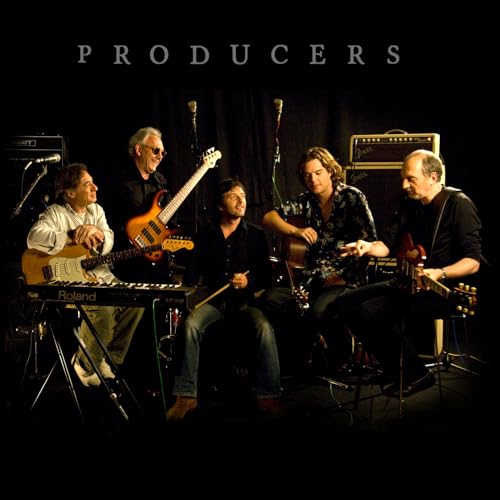 Five musicians with guitars and keyboards in a dimly lit room.