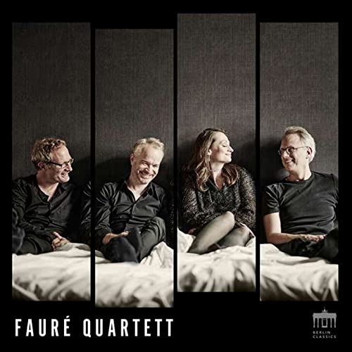 Four musicians of the Faure Quartet posed against a gray, textured background.