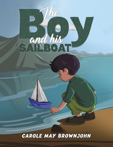 Boy kneels by a small sailboat on a sandy shore.