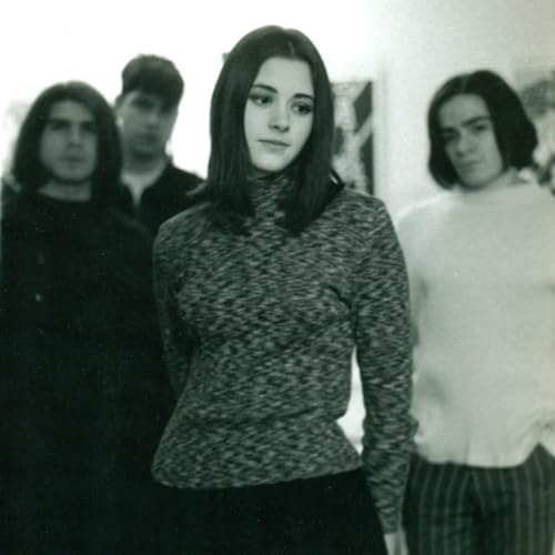 Black and white photo of four people, likely a band, looking at the camera.