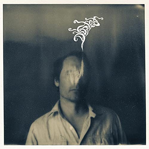 CD cover: grayscale portrait of a man with abstract white design.