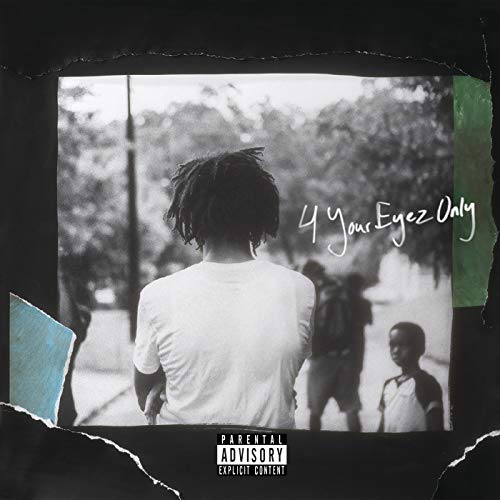 Black and white photo of J. Cole seen from behind with a child nearby.