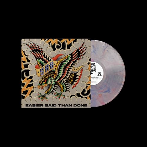 Vinyl record with eagle tattoo album art and marbled pink/blue disc.