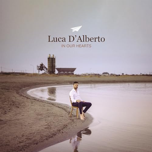 Album cover: man by water, industrial landscape in background.