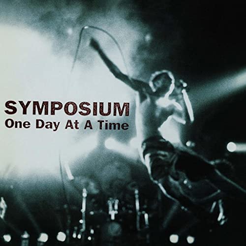 Vinyl album cover for Symposium’s “One Day At A Time,” featuring a performer.