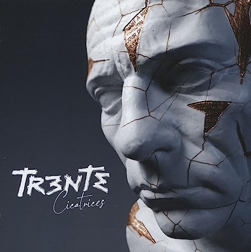 CD cover: cracked, white face sculpture with gold-lined fissures.