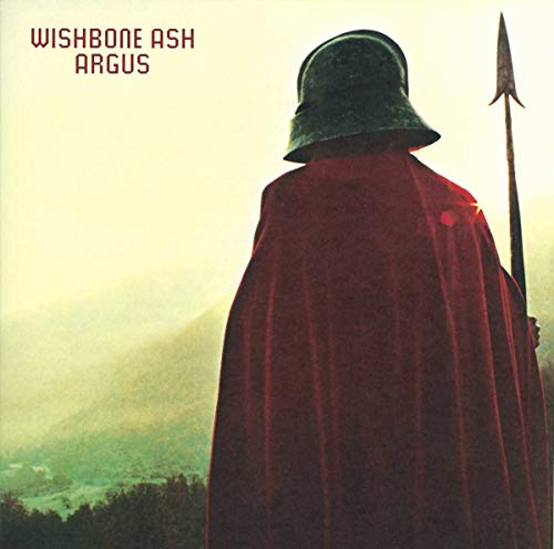 A figure in a helmet and red cloak holds a spear against a landscape.