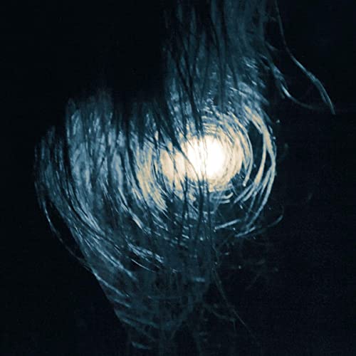 Dark, swirling abstract image with a bright central light source.