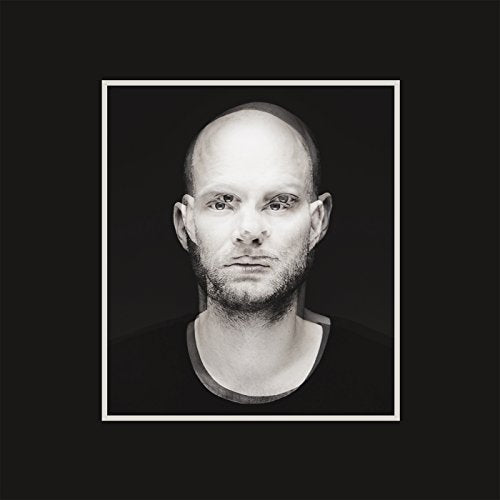 Black and white portrait of Tomas Barfod, a bald man with a beard.