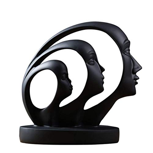 Black abstract sculpture of three faces in profile on a base.