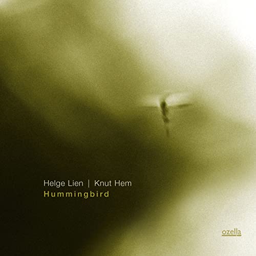 CD cover: blurry green image of a hummingbird in flight.