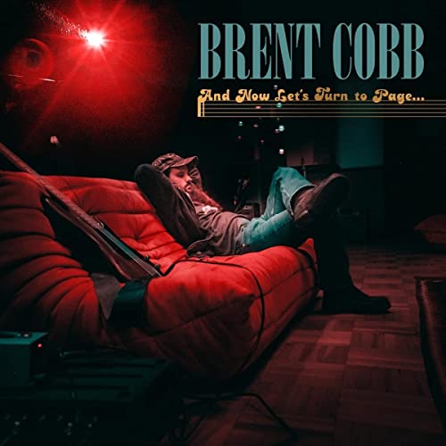 Brent Cobb album cover: man reclining on a red couch with guitar.