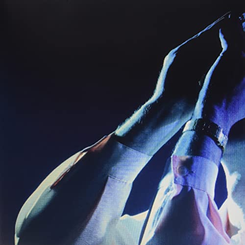 Dark blue album cover with a close-up of arms and a watch.
