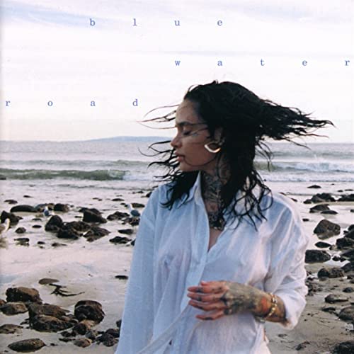 Kehlani on album cover, standing on a rocky beach, looking right.